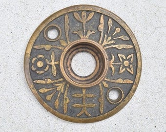 vintage door knob rosette with floral design / antique early 1900s rosette door hardware
