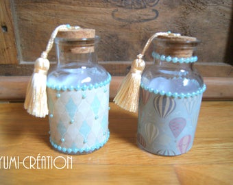 Pair of little blue bottles with PomPoms