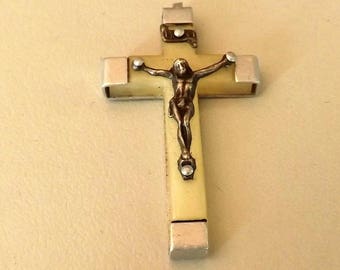 Cream and silver metal cross pendant