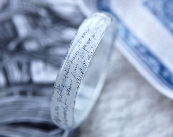 Resin bangle with embedded vintage art of a wet letter
