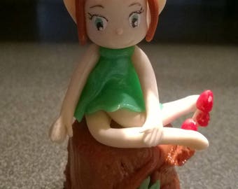 Figurine: Mimie IMP sitting on a tree in cold porcelain