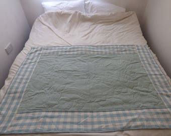 A wholecloth quilt with a lovely gingham border. Blue/green/cream. Cot/cot bed quilt, single topper, lap quilt or sofa throw. Handquilted.
