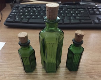 3 Green glass bottles with cork stoppers