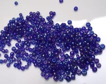500 seed beads blue color glass dark iridescent 3 mm on average.