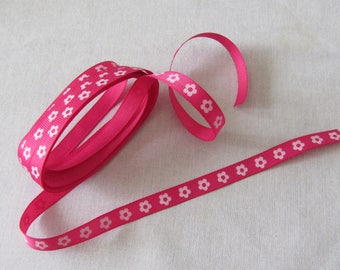 Pink Ribbon backed with small flowers for embellishments