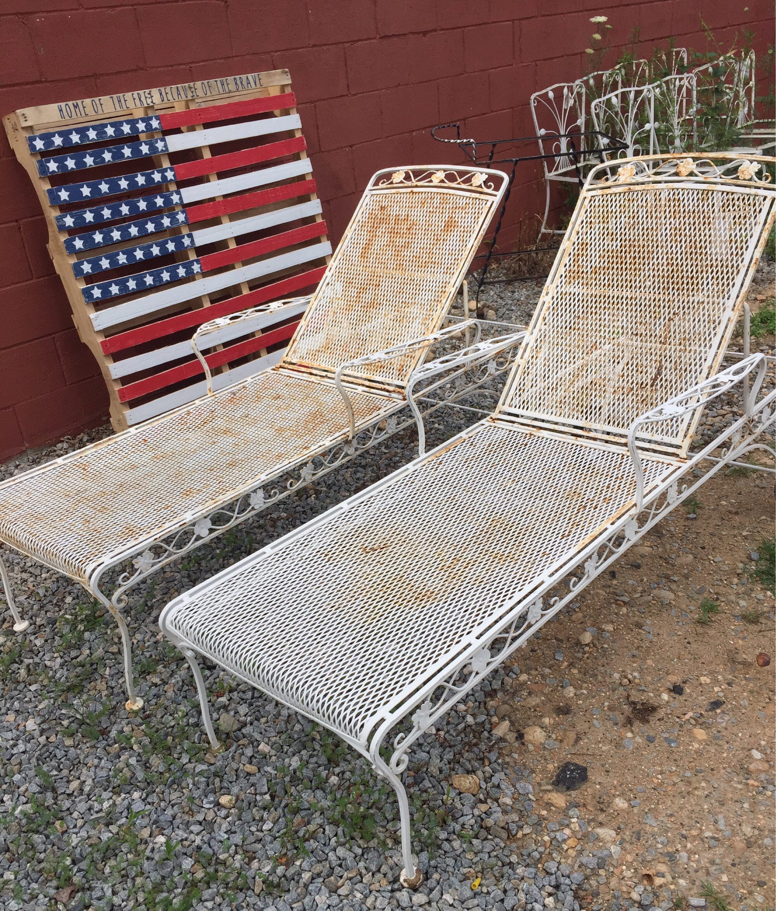 Vintage pair of iron chaise lounge chairs with wheels