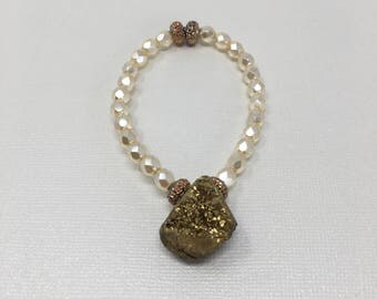 Beautiful pearl crystals made with amber gold accents and a gold druzy charm