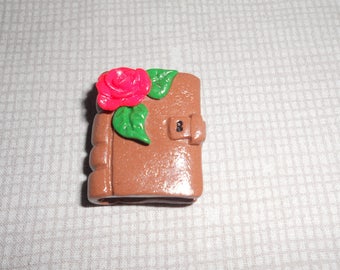 Romantic pendant: old diary and decorated with a red rose