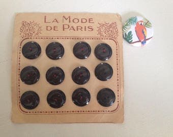 Old plate of 12 black buttons