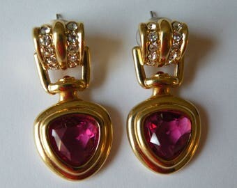 Swarovski swan logo stud earrings. Fuchsia pink clear rhinestone, gold plated metal.