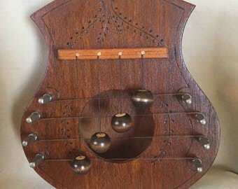 Vintage Wood Door Harp Door Chime with Delicate Carved Design amd Warm Reddish Brown Color and Acorn Look Wood Clappers made by Dale Andrews