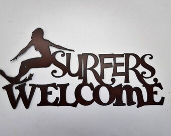 Surfers welcome sign made out of rusted metal surfer girl