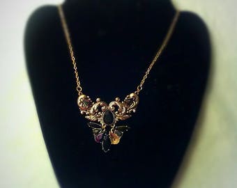 This one of a kind necklace has faux onyx and gold
