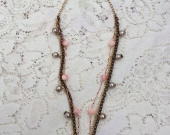 Triple strand necklace with floral focal