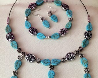 A set of jewelry from turquoise. Ornaments from natural stones. Necklace, turquoise earrings with antique beads and charms. Bijouterie.