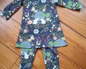 Baby tunic set -sewn in a cotton knit with matching leggings in a navy/teal print with white bunnies and flowers.