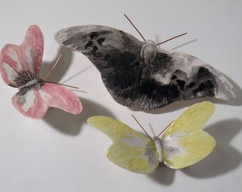 Hand-painted and made ceramic butterflies. The colors are fictional but real butterflies are two shapes.