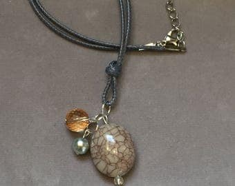 Stone pendant and bead accent cord necklace