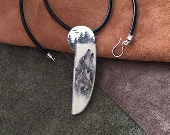 Sterling Silver Necklace with scrimshaw howling wolves on fossil ivory.