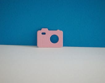 Cut-out camera flash in pale pink creating drawing paper