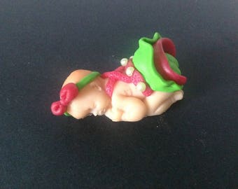 polymer clay with a green and pink dress baby