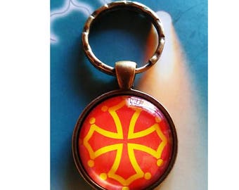 A pretty Keychain with a glass cabochon 30 mm cross L'Occitane