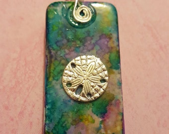 Multicolored domino with silver sand dollar charm