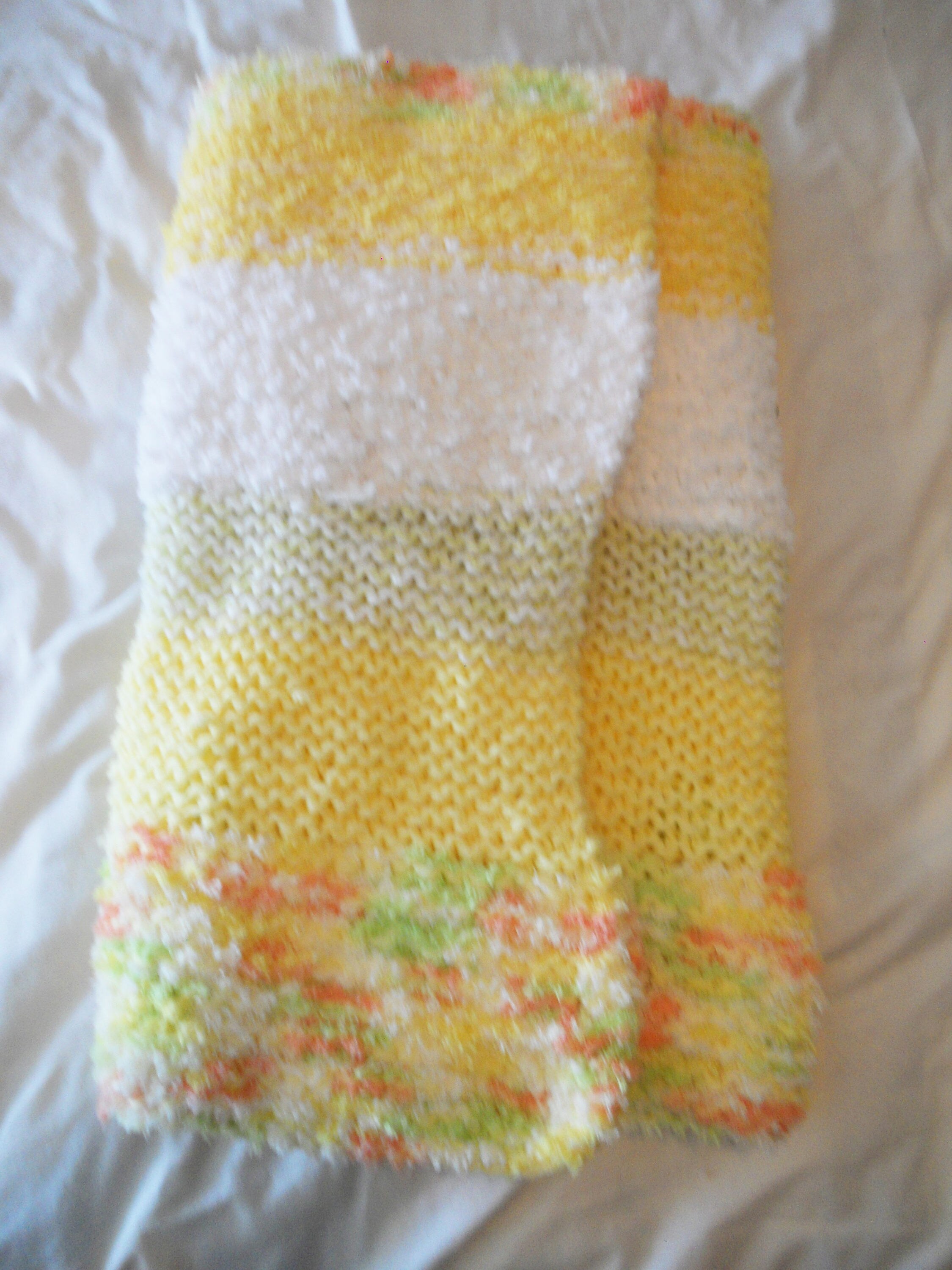 Knitted baby blanket in fluffy Pipsqueak yarn in yellows