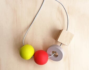 Handmade shapes necklace — Red, lemon, grey and natural clay and wood beads.