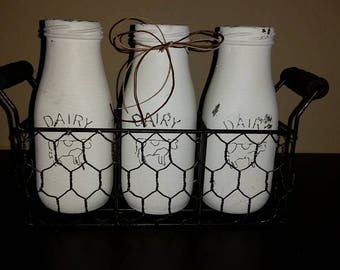 RESERVED FOR DENISE S.Milk Bottle Candle Set of 3 in wire basket with wood handles, Snickerdoodle scent, bottles painted white distressed