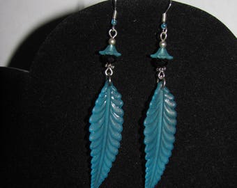 Feather earrings in sky blue lucite