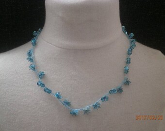 Beaded necklace and blue and turquoise glitter.
