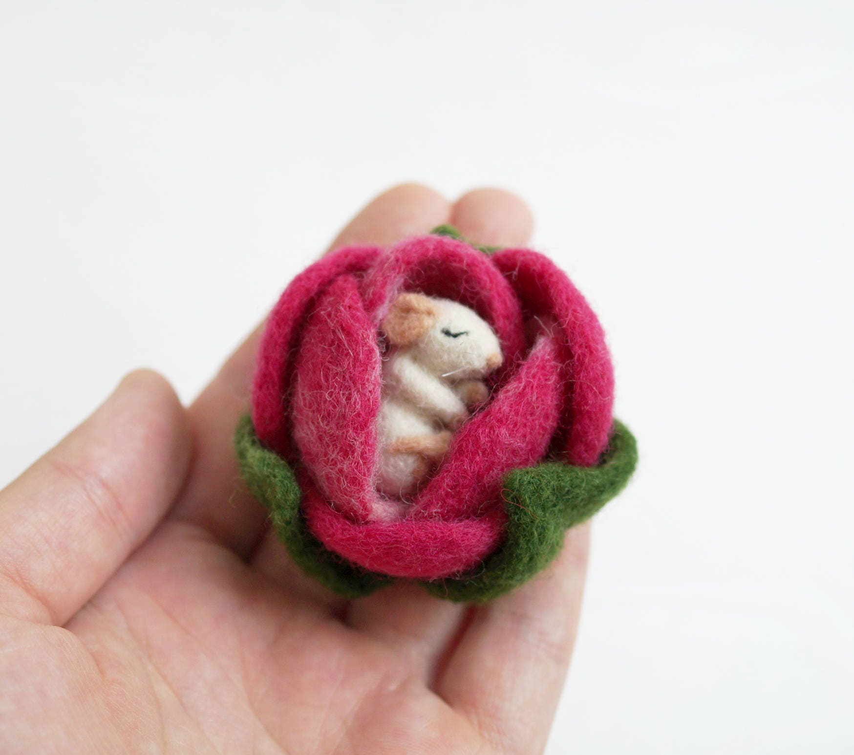 Tiny mouse sleeping in a flower