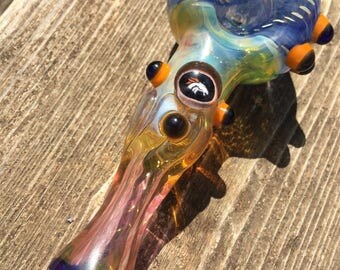 Denver Glass pipe Denver glass millie with orange and blue highlights. Fumed with silver and gold, color changing. Awesome piece