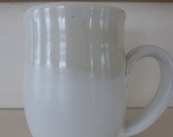 Stoneware mug in creamy white with opal overlay on top half.