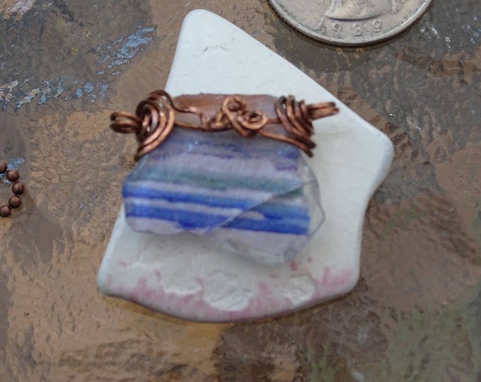 Small piece of Lake Michigan Beach Glass with an image of Chicago Skyline Wire wrapped in copper as a pendant or a bracelet