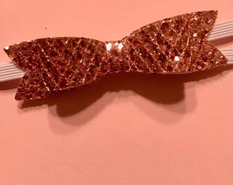 Pink glitter shiny bow. Elastic headband.