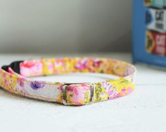 Floral Cat Collar Yellow - safety clip. Bright yellow cat collar with purple and pink flowers, quick release and metal fittings.