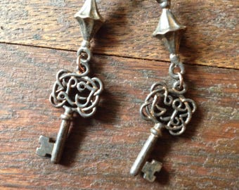 Rustic antique key earrings on copper ear wires.