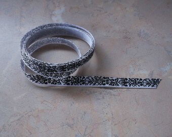 Ribbon grosgrain white with black designs. 10mm