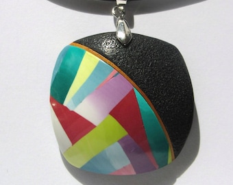 Rounded square polymer clay pendant.