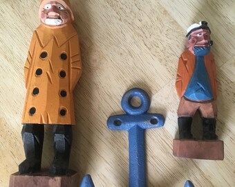 Hand carved wood fishermen and cast iron anchor