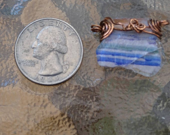 Small piece of Lake Michigan Beach Glass with an image of Chicago Skyline Wire wrapped in copper as a pendant or a bracelet