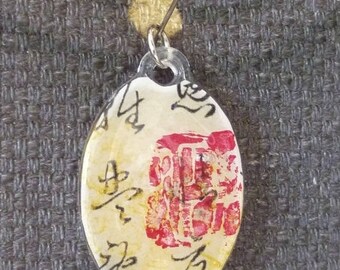 Resin oval pendant with Chinese motif