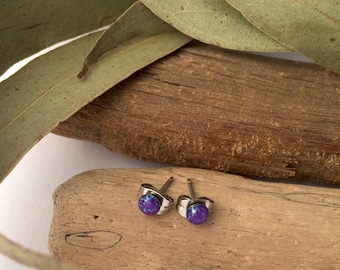 New improved waterproof design! Itty bitty, purple eco-resin studs with iridescent sparkles of reflective glitter.