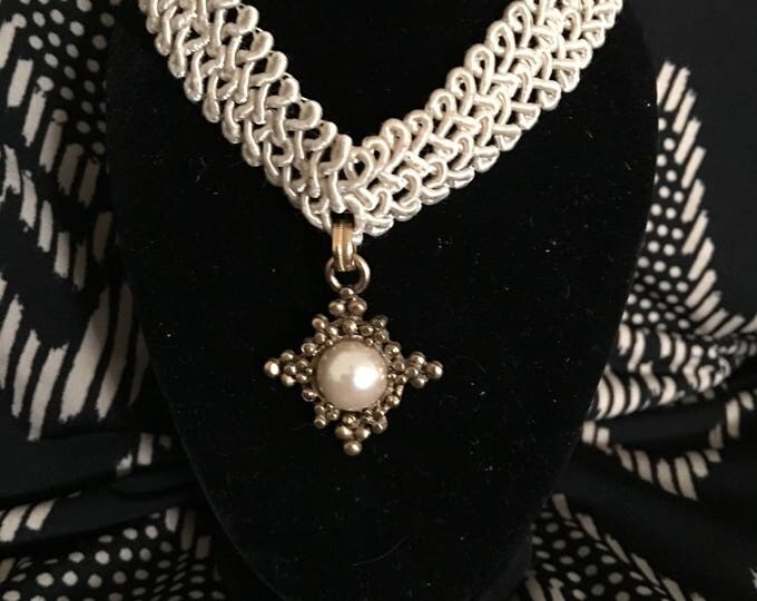 Cream colored cord with gold tone pearl choker necklace