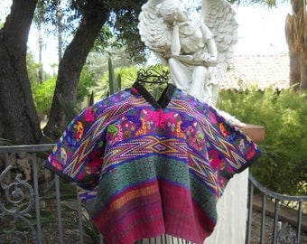 Traditional Guatemalan blouse "huipil" froom Santiago Atitlan. 31 x 39 inches. Loom woven blue and magenta huipil with hand embroidery.