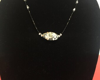 Seed bead necklace with glass centerpiece and grey, black, white details