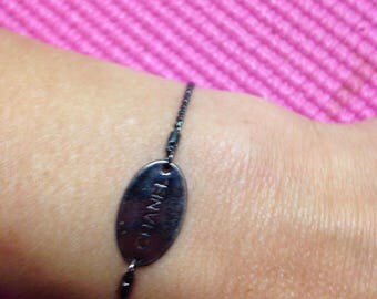 Gunmetal Chanel tag repurposed into the bracelet