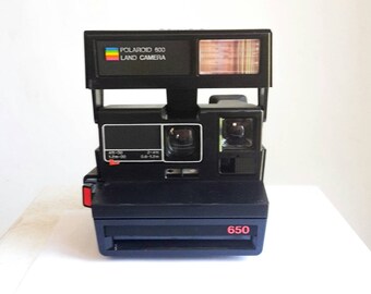 Polaroid camera black 650. Running